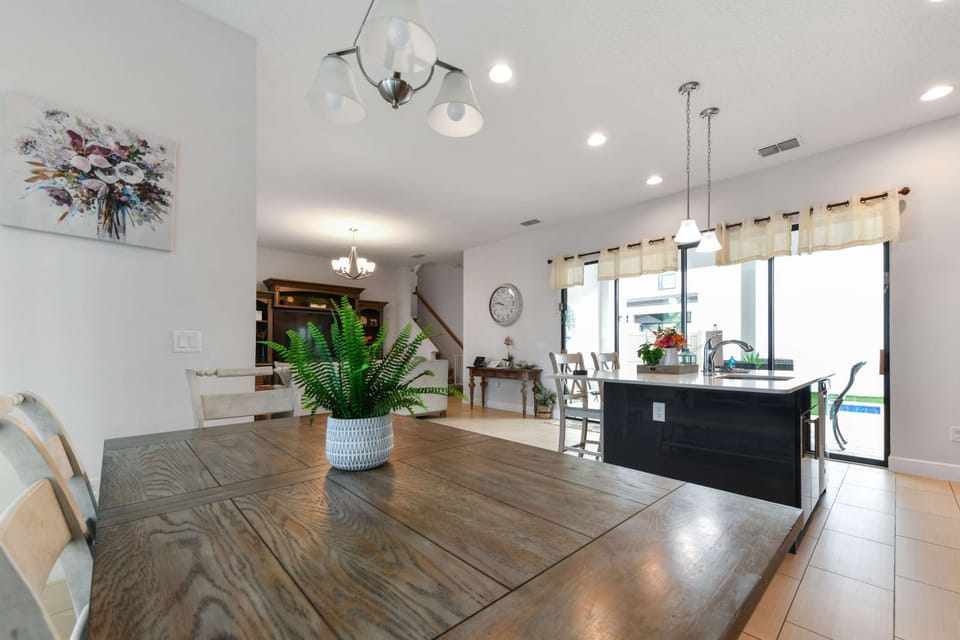 Open-concept dining and kitchen area with natural light and modern fixtures