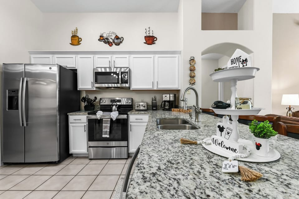 Kitchen Area with Refrigerator, Microwave Oven, Gas stove, Coffee Maker, Kitchen Utensils, and Kitchen wares