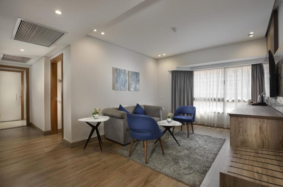 Deluxe Suite, 2 Bedrooms | Living area | 32-inch LCD TV with satellite channels, TV