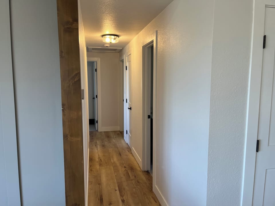 Hallway leading to 3 bedrooms on the main level. 