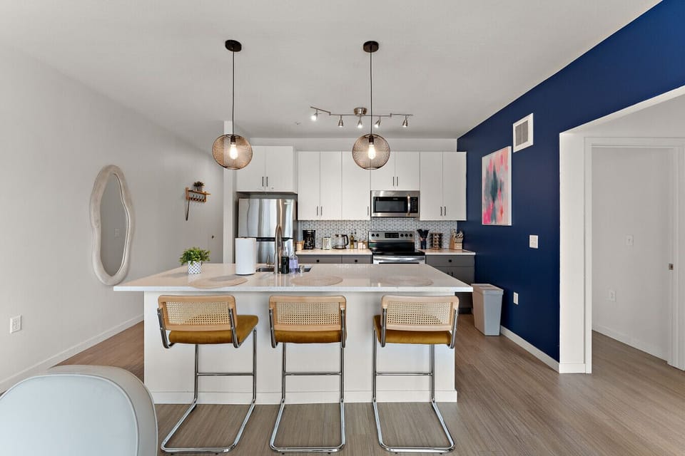 Stylish modern kitchen with chic lighting and sleek appliances for culinary adventures!