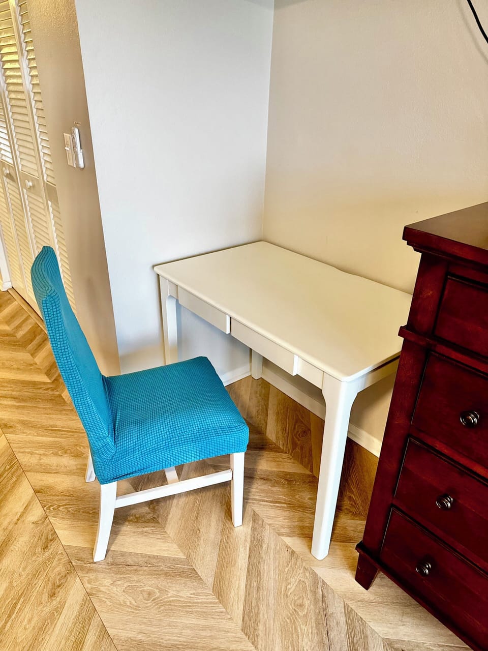    Dedicated workspace with desk and chair in the master bedroom.