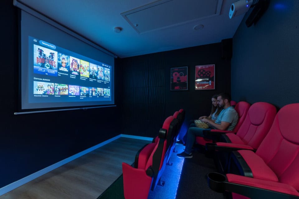 Private home theater with real cinema seating and streaming access.