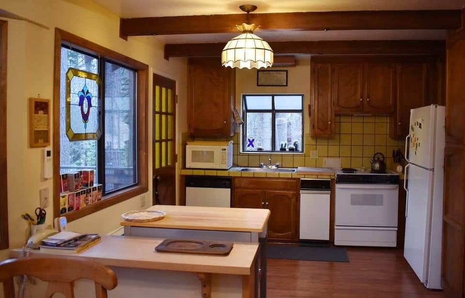 Kitchen connects to deck for dining among the pines.