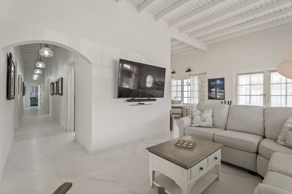 A comfortable sofa and Smart TV make this living space great for relaxing after a beach day.