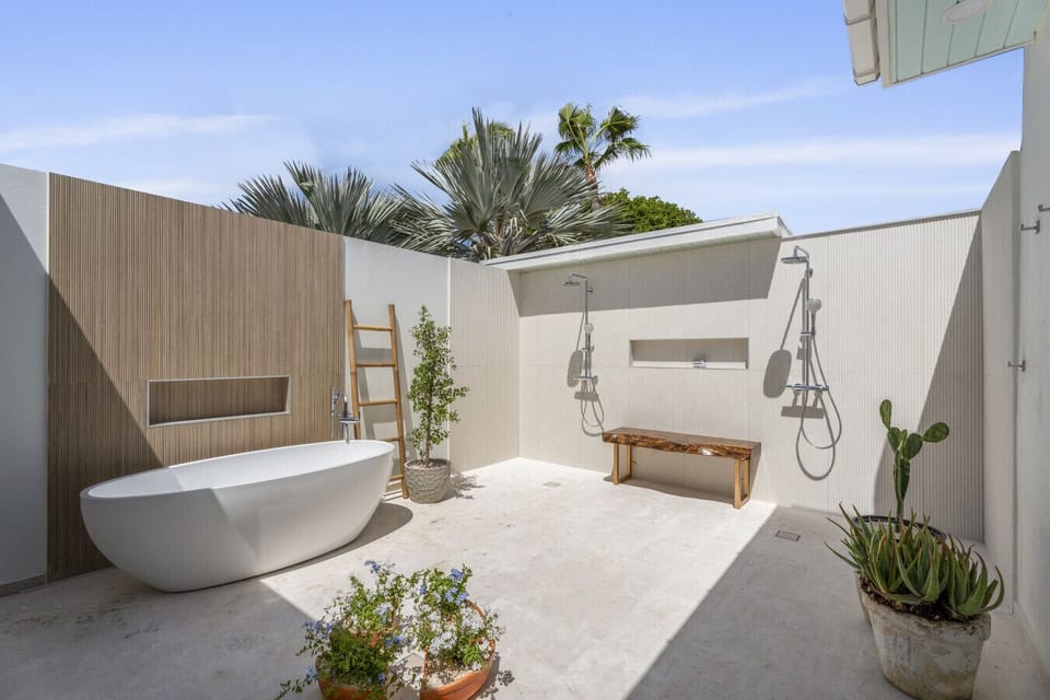 Newly built and beautifully designed, this open-air ensuite bathroom includes a freestanding bathtub and dual showers—your own tropical spa experience.