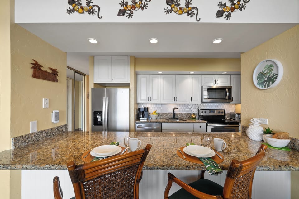Fully equipped kitchen featuring a stylish backsplash and ample counter space.