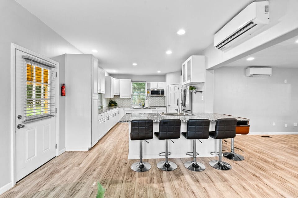 Kitchen | Granite counters, large island with seating, and modern appliances