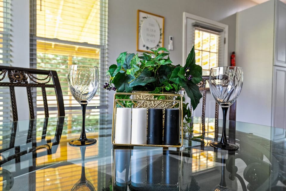 Breakfast Nook | Cozy round glass table with seating for four, adjacent to kitchen and dining room