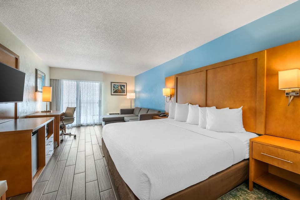 Stretch out in crisp linens with cozy seating by the window.