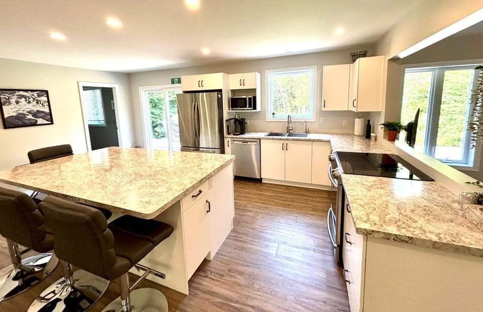 Gather around the spacious island in this bright, open-concept kitchen—perfect for morning coffee or evening laughs.