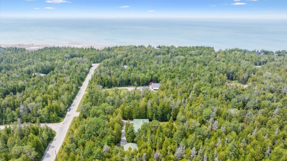 Set on a quiet residential road with Lake Huron nearby, this property blends convenience with tranquility.