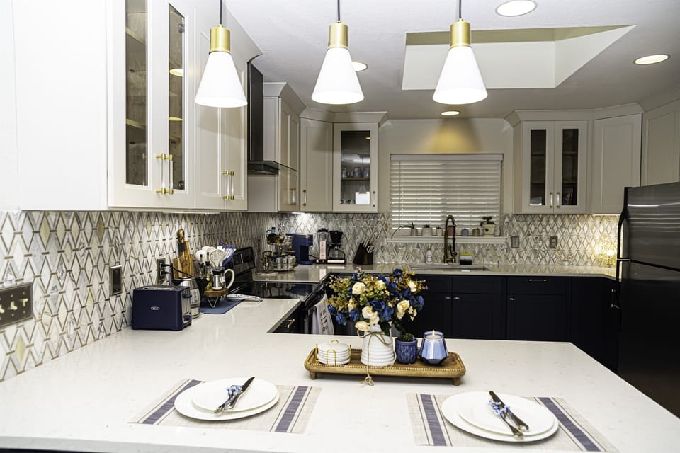  Whether gathered around the table for a formal dinner or enjoying a casual breakfast at the island, the kitchen seamlessly blends with the dining area, creating a cohesive and inviting space for entertaining.
