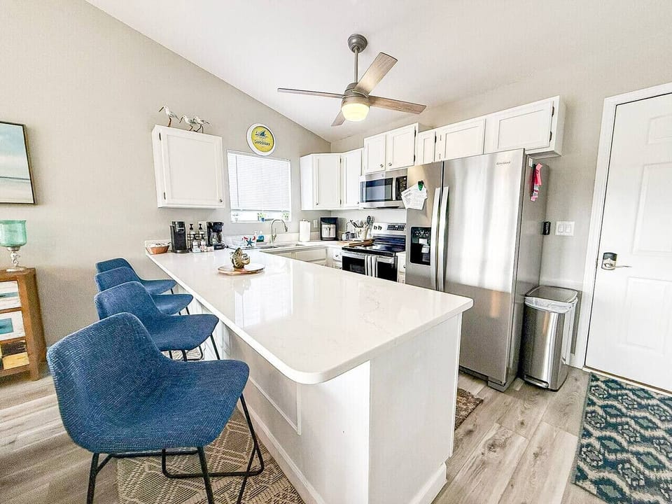 Stylish kitchen with island seating and stainless appliances.