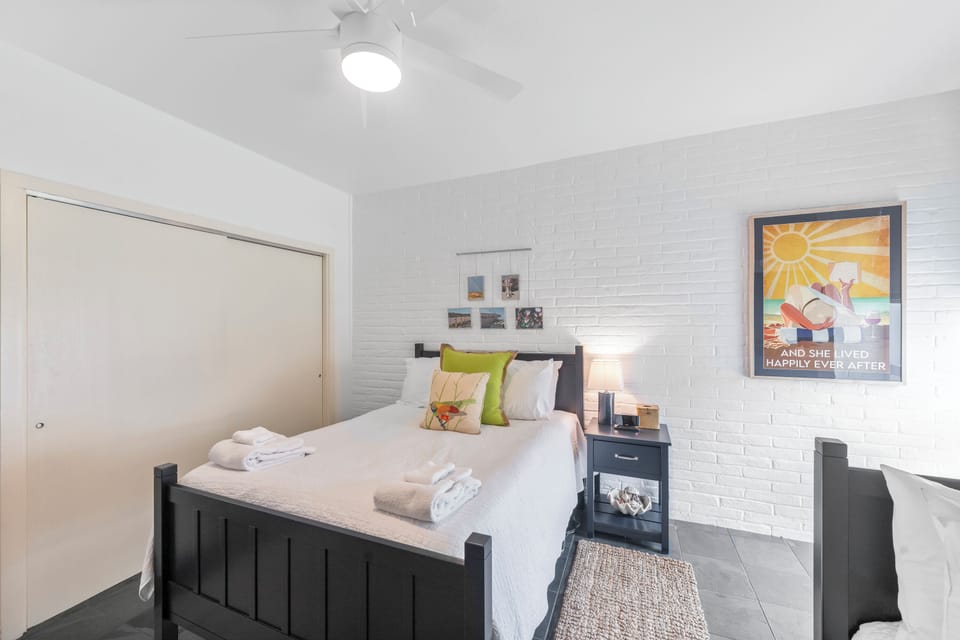 Unwind in your bright bedroom with crisp linens, exposed brick walls, and thoughtful touches that make every night feel like home.