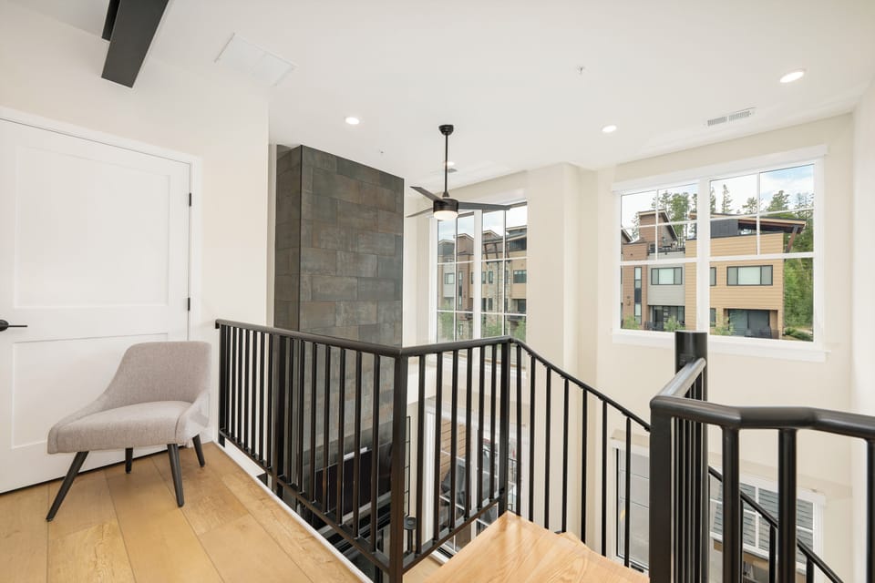 Your upstairs landing offers a peaceful retreat with a cozy reading nook and bright windows showcasing neighborhood views.