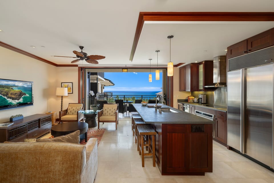 Wide-angle view reveals full great room and shimmering horizon.