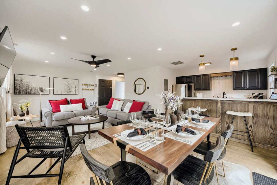 Your spacious open-plan living area flows seamlessly from cozy sofas to elegant dining, perfect for memorable meals and relaxation.