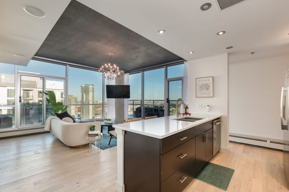 Extended-height living room with dramatic evening city lights