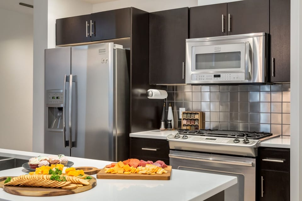Fully equipped kitchen with stainless steel appliances and breakfast bar