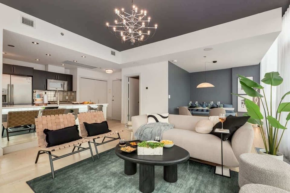Open-concept living and dining with designer furnishings and city panorama