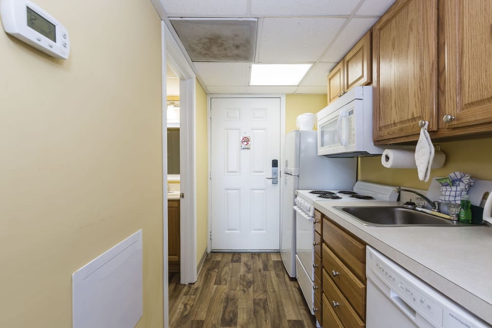 Open kitchen and entryway with full-size appliances for easy meals.