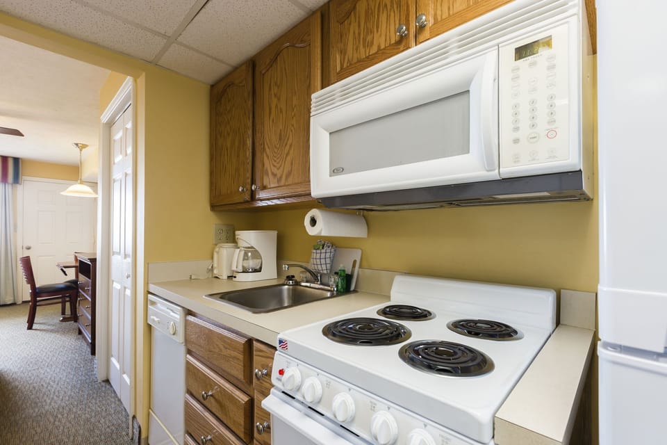 Fully equipped kitchen with stove, oven, microwave, and essentials.