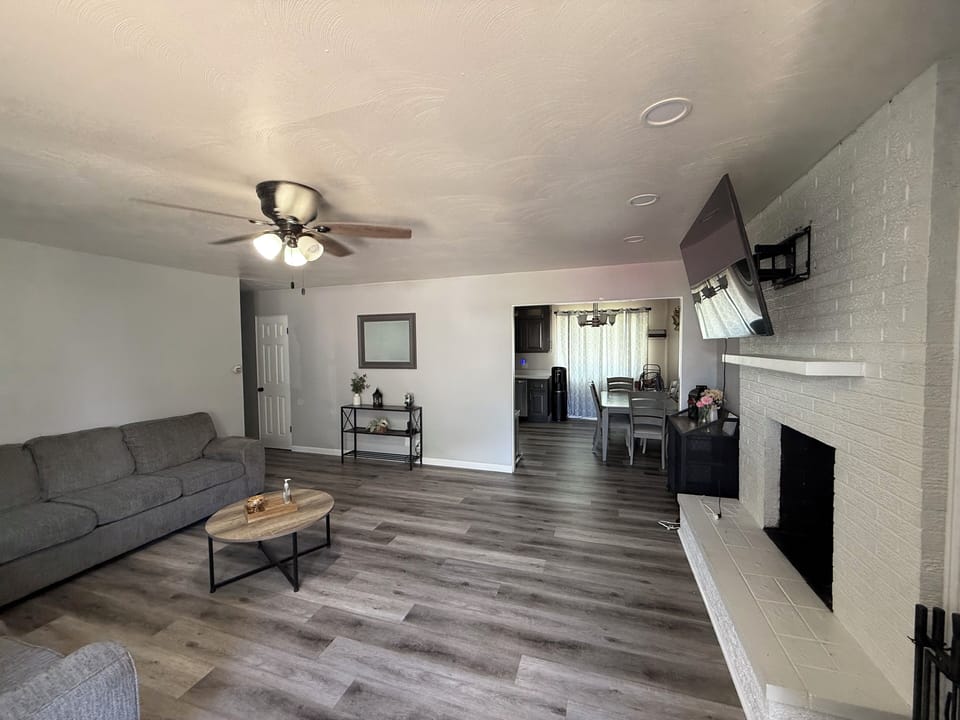 Living room showing coffee table and newer fan