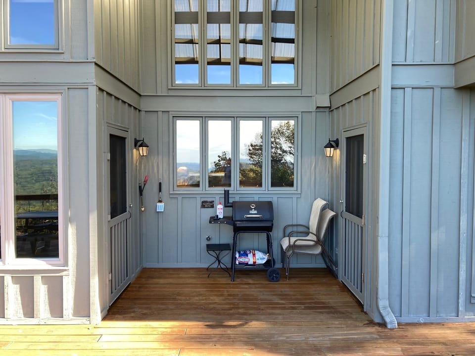 Upper-level deck looking into the kitchen with charcoal grill ready to go.