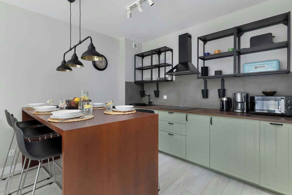 Kitchenette with plenty of kitchen utensils and dishes.