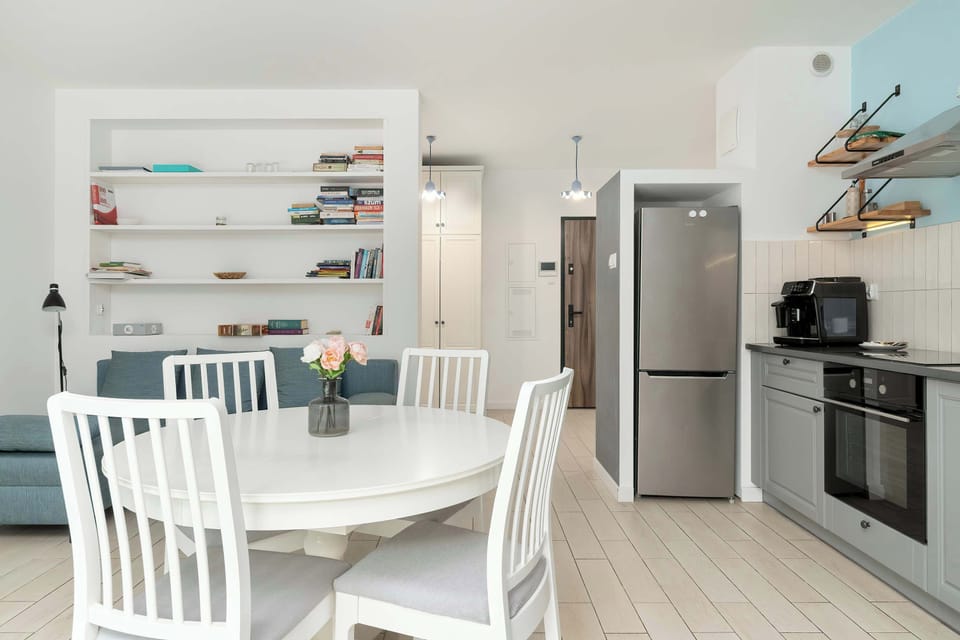 Modern kitchen with gray cabinets and dining area.