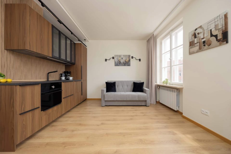 Spacious living area with grey sofa bed.