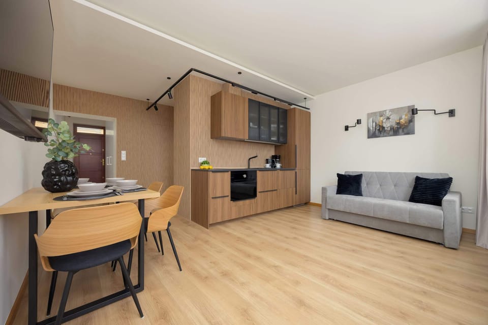 Open-plan kitchen and dining area with wooden finishes and modern decor.

