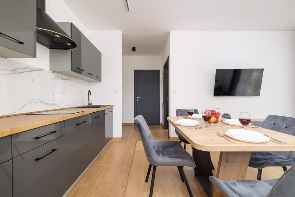 Modern kitchenette with grey furniture.