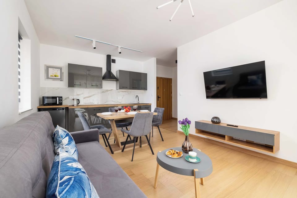 Comfortable lounge with dining table and entertainment.