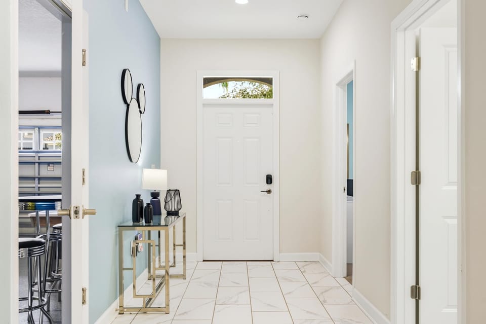 Bright tiled hallway opens into the living area with soft, natural light.