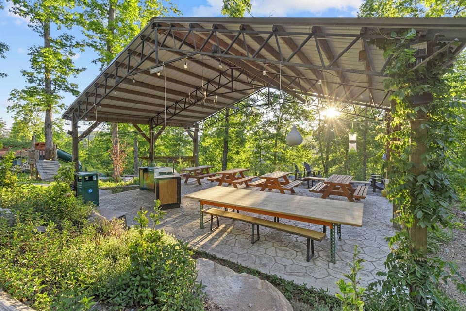 Central Pavilion with cold-water outdoor kitchen, picnic tables, and additional firepit. Nearby are the chicken coop, play space, tetherball, cob oven, trailhead, and ceremony hut
