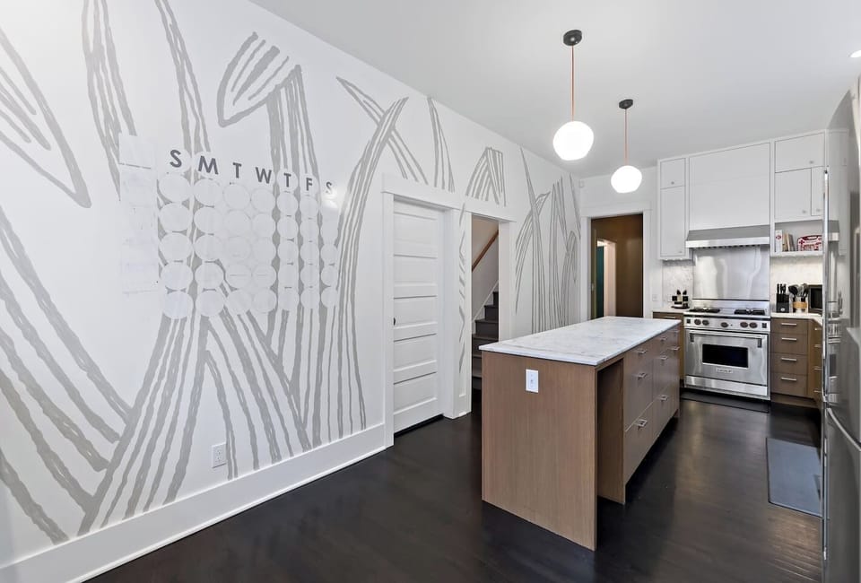 A vibrant hand-painted mural adds a touch of personality and charm, while the kitchen comes fully stocked with cookware, utensils, and top-of-the-line appliances for all your culinary needs.