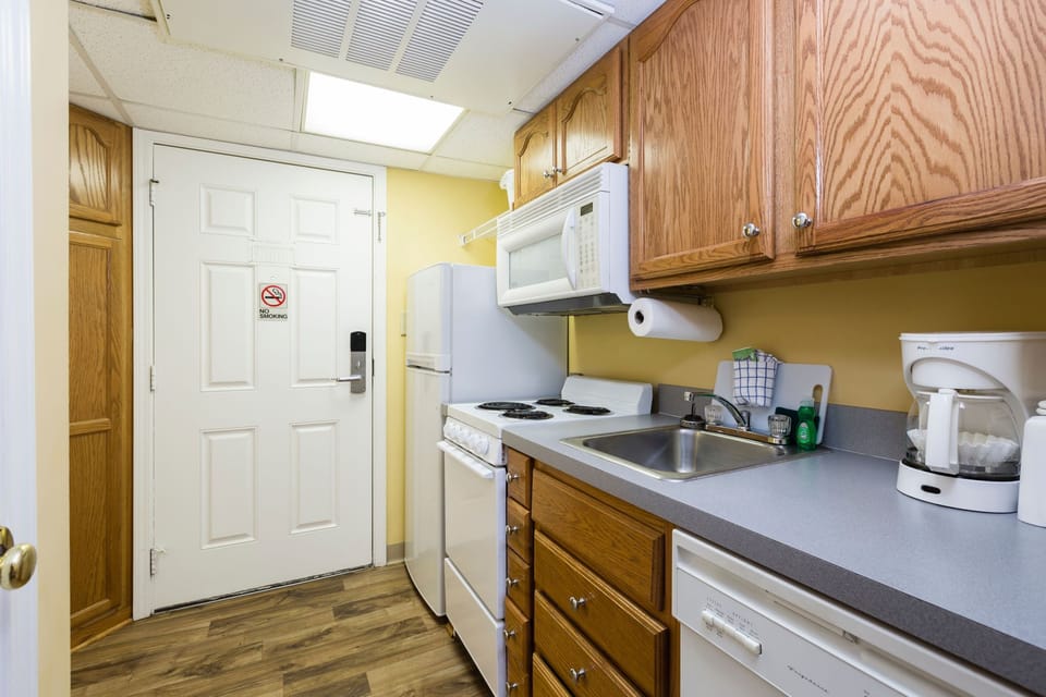 Compact kitchenette with full-size appliances for easy in-room dining.