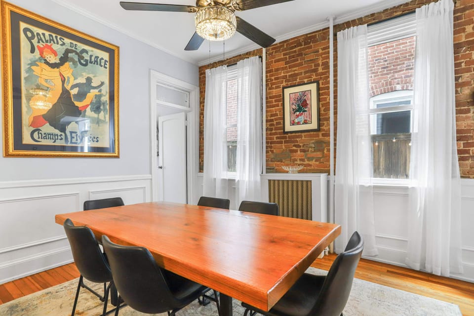 Dining area featuring dining set, ceiling fan and a door that leads to the kitchen.