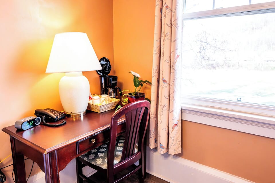 Catch up on emails at a sunny desk with coffee nearby