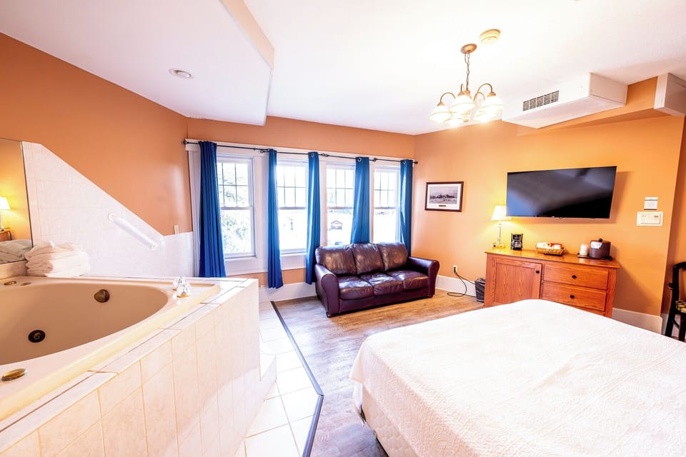 Soak beside sunlit windows, then lounge on the leather sofa.