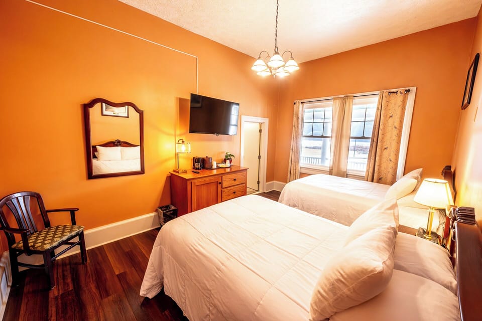 Recharge in a calm room with seating, mirror, and TV.