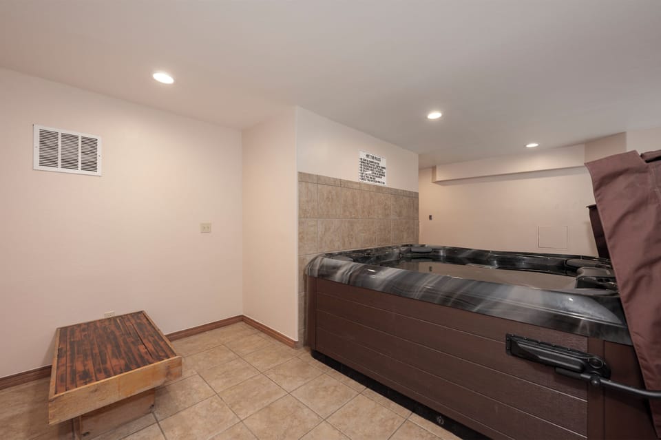 Unwind in the common area hot tub sanctuary, where warm bubbles melt away stress in this intimate basement retreat.