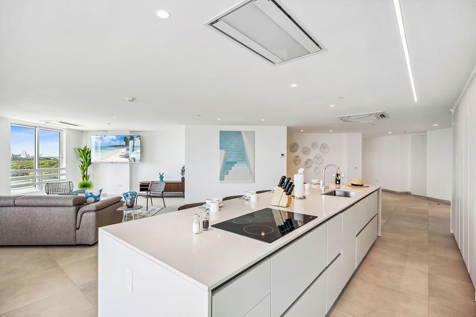 Cook your favorite meals in this sleek, modern kitchen with a spacious island, while enjoying bright natural light and open views of the living area.