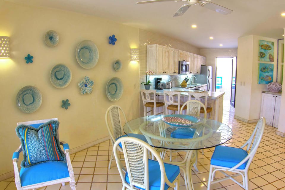 Bright and beachy dining space with a fully equipped kitchen.