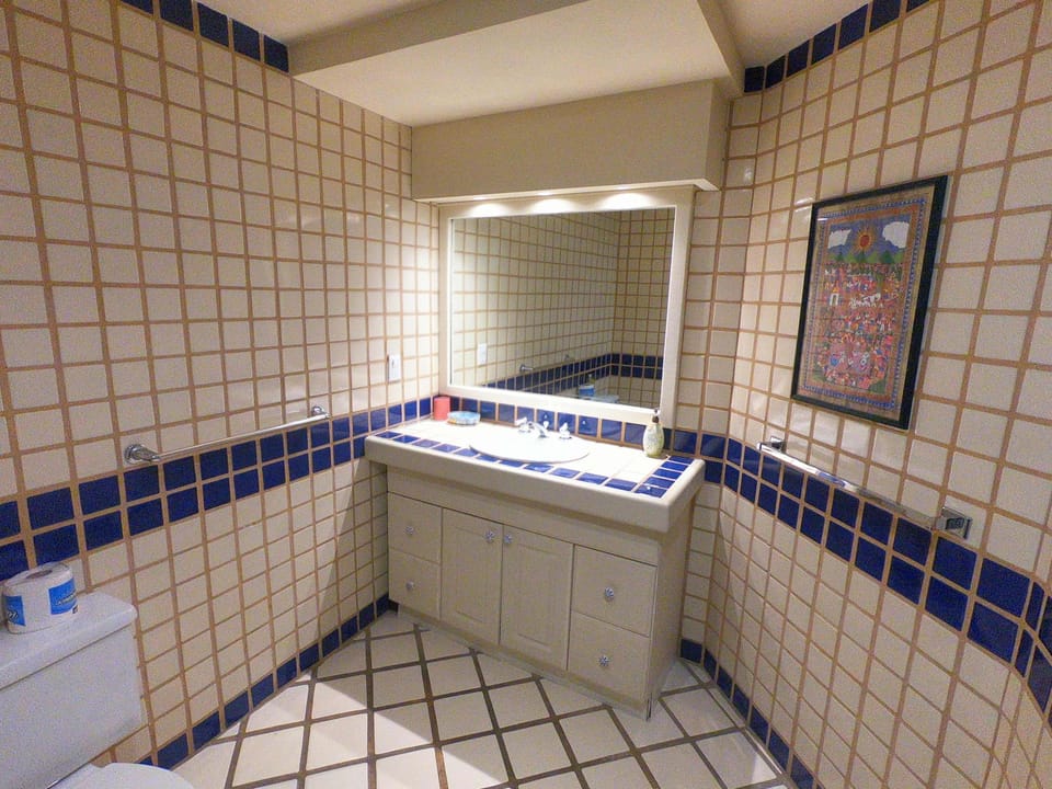 Fully tiled bathroom is part of the eclectic decor 