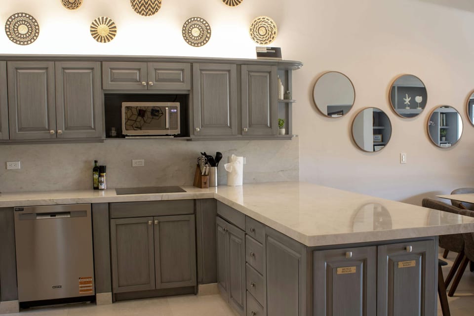 Sleek grey cabinetry and high-end appliances for your stay.