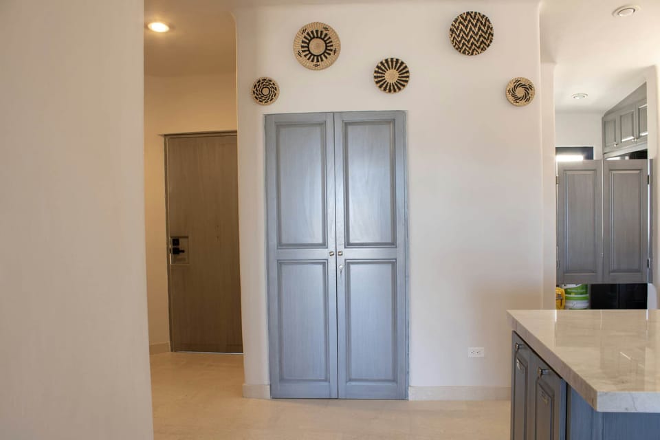 Organized and tidy entryway with plenty of closet storage space.