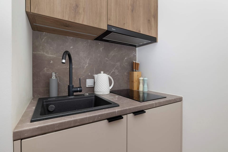 The sleek design of the kitchenette blending seamlessly with the living area.